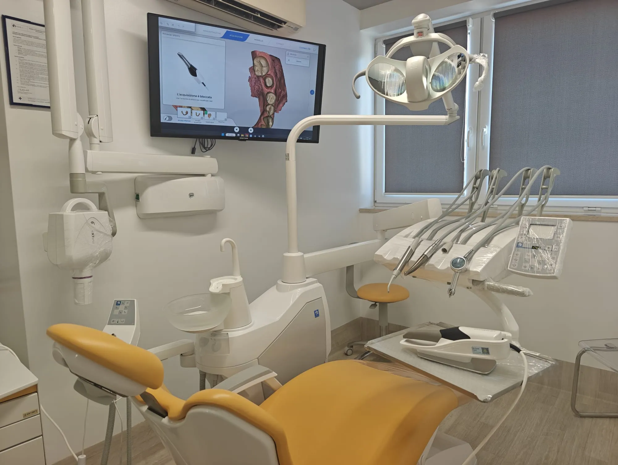 Uno studio odontoiatrico con la poltrona e il monitor per le immagini digitali